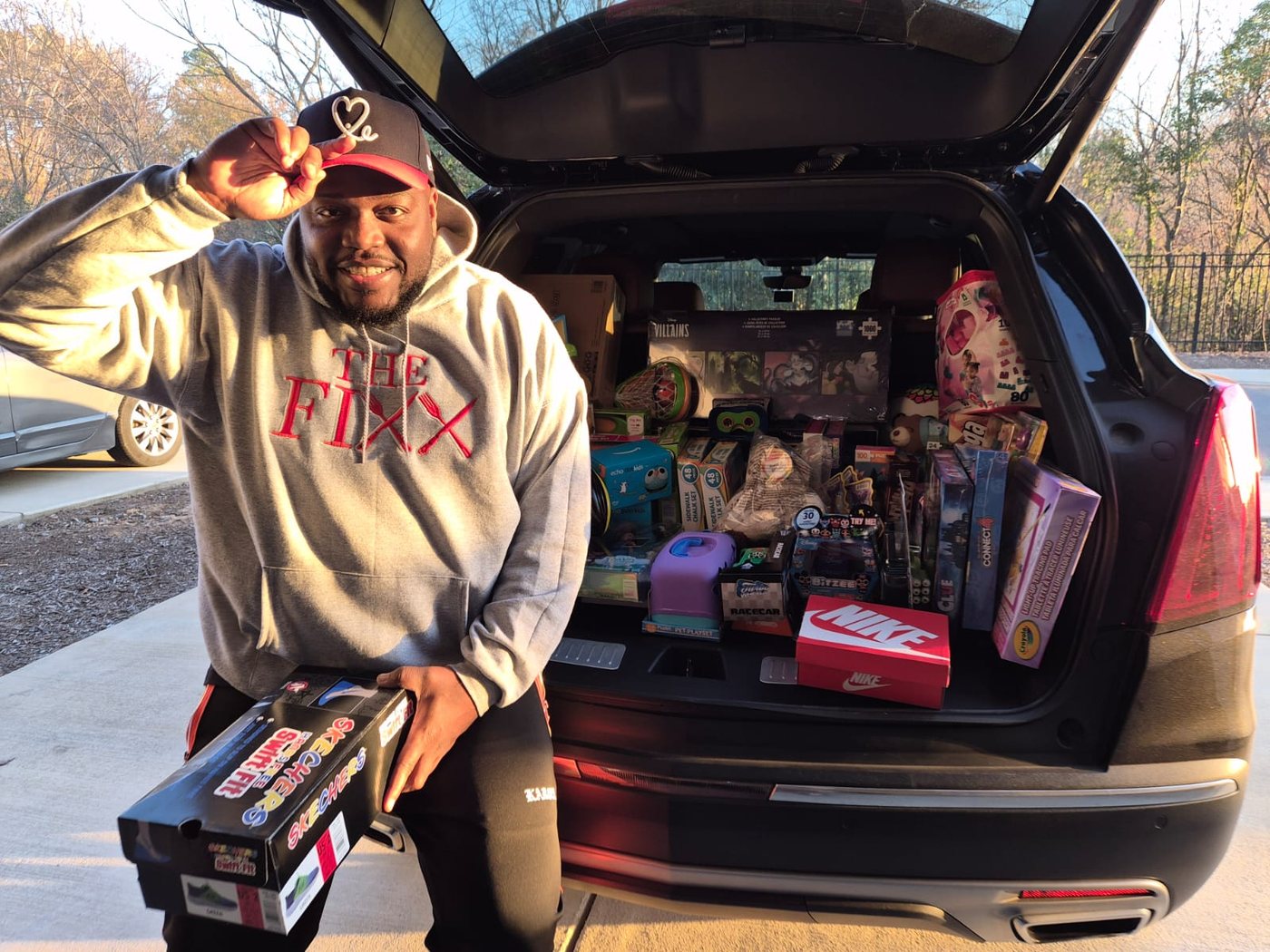 Founder Kareem Pearson with a vehicle full of donated toys and gifts for the community